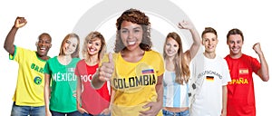 Laughing soccer supporter from Colombia with fans from other countries