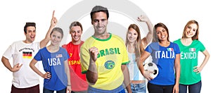 Laughing sports fan from Brazil with fans from other countries