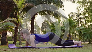 Laughing Sportswoman Attempt Side Plank Exercise on Sports Mat in Nature
