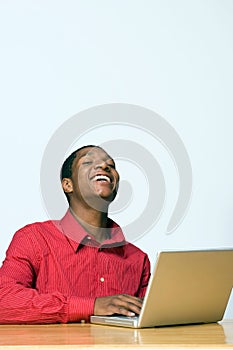 Laughing Student on Laptop - Vertical