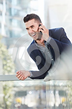 Laughing successful business man on mobile phone call