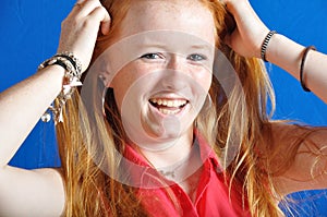 Laughing teen on blue background