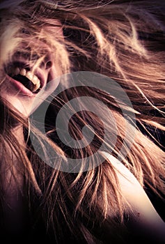 Laughing teen girl with hair flying around