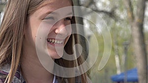 Laughing Teenager Girl Playing at Playground in Park, Adolescent Kid Smiling, Happy Young Child Portrait Laughs, Children Outdoor