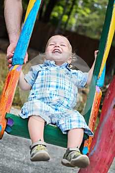 Laughing toddler boy riding