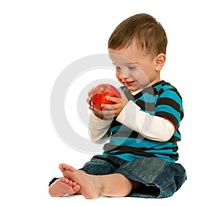 Laughing toddler holds a red apple