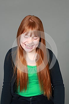 Laughing tween redhead girl with freckles