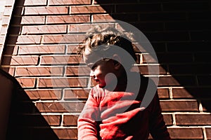 Laughing two-year-old girl greets the sun on the terrace of her apartment