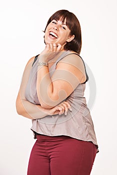 Laughing it up. Portrait of a happy young woman laughing on a white background.