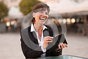 Laughing vivacious woman making a payment