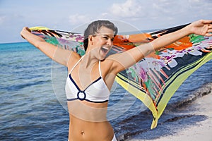 Laughing vivacious woman at the seaside