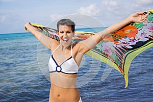 Laughing vivacious woman at the seaside