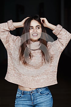 laughing white Caucasian brunette young beautiful girl woman model with long dark hair and brown eyes in turtleneck sweater