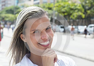 Laughing woman with blonde hair in the city