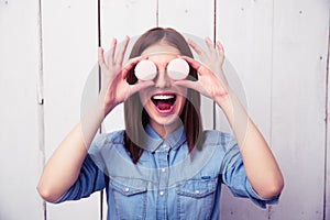 Laughing woman closing her eyes with round cookies