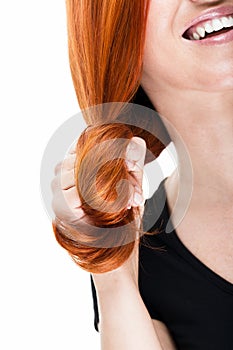Laughing woman coiling her red hair photo