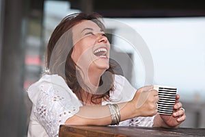 Laughing woman with a cup of drink