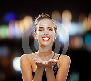 Laughing woman in evening dress holding something