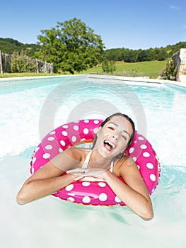 Laughing Woman Floating in Pool