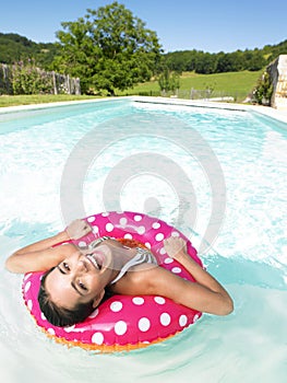 Laughing Woman Floating in Pool
