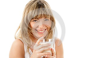 Laughing woman with glass of milk