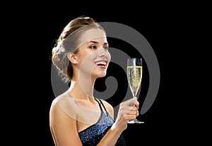 Laughing woman holding glass of sparkling wine