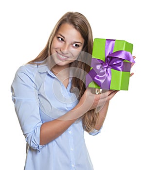 Laughing woman listens on a christmas gift