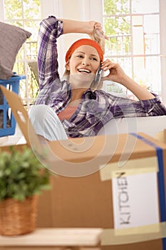 Laughing woman with mobilephone at moving