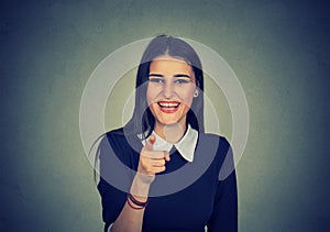 Laughing woman pointing finger at camera