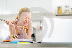 Laughing woman spread toast with chocolate cream