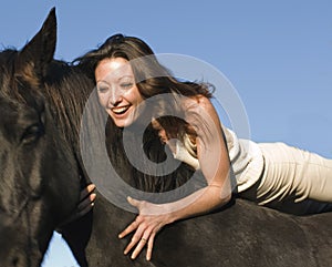 Laughing woman and stallion photo