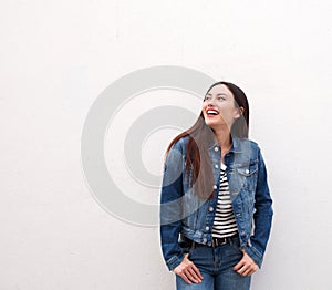 Laughing woman standing in denim jacket