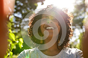 Laughing woman taking a selfie outside on a sunny day