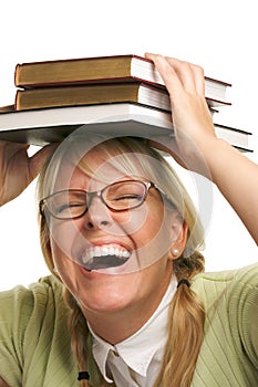 Laughing Woman Under Stack of Books on Head