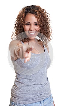 Laughing woman from Venezuela pointing at camera