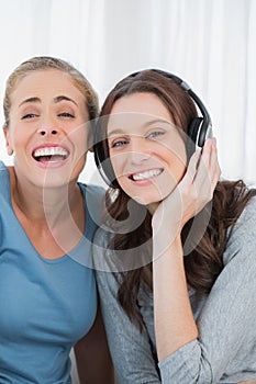 Laughing women listening to music