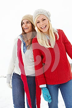 Laughing, women and snow in Switzerland for joke, game and enjoyment together on holiday. Happy friends, humor and funny
