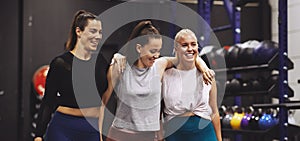 Laughing women walking in a gym after a workout