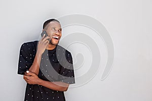 Laughing young african man talking on cell phone