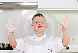 Laughing young boy with floury hands