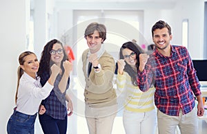 Laughing young business entrepreneurs in trendy clothing celebrating a success