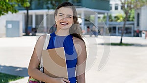 Laughing young caucasian female student with brunette hair