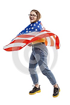 Laughing young girl with american flag. Celebrating Independence Day. Isolated on a white background. Vertical