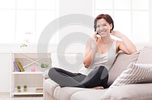 Laughing young girl calling on mobile phone