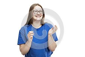 Laughing young girl in glasses and a blue T-shirt. Isolated on a white background. Close-up. Space for text