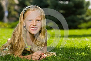 Laughing young girl on the grass