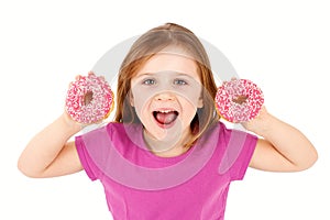 Laughing young girl holding donuts, isolated background