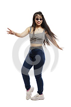 Laughing young girl in jeans. Brunette with long hair wearing sun glasses. Isolated on a white background. Vertical. Full height