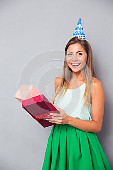 Laughing young girl opening gift box