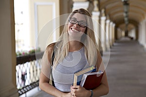 Laughing young girl, a student or a schoolgirl posing for a por